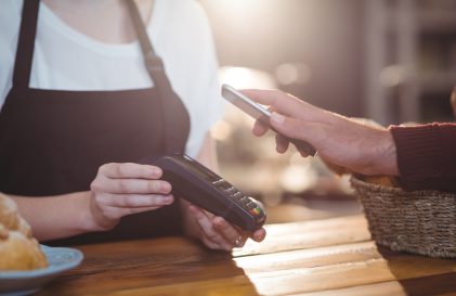 Mobile Phone paying a merchant with mobile wallet